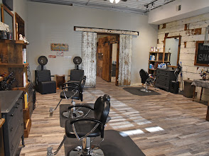 Salon 11 styling stations with reclaimed wood wall