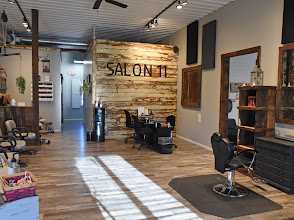 Salon 11 interior, reclaimed wood accent wall with the Salon 11 sign